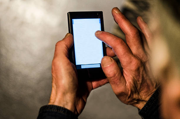 istock Old mann with grey hair communicating on a smartphone 502127722