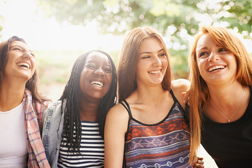 A cropped shot of four laughing girls sitting outdoorshttp://195.154.178.81/DATA/i_collage/pi/shoots/783608.jpg