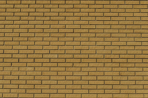 istock wall of  yellow raised thin bricks 502130750