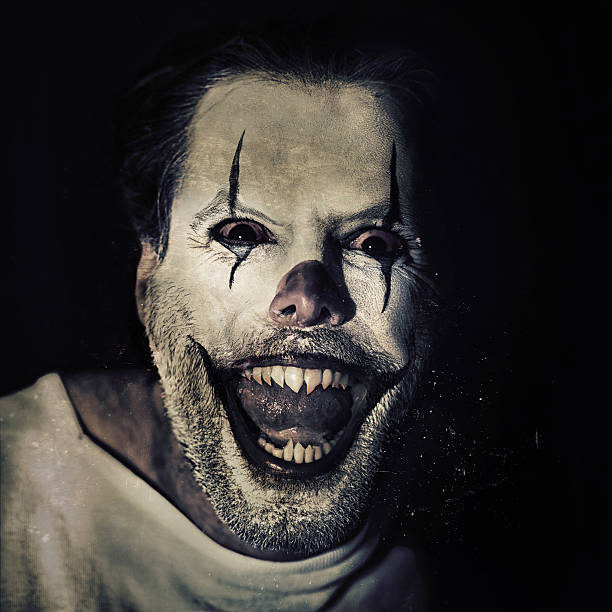 Portrait of an evil clown with face paint on a black backgroundhttp://195.154.178.81/DATA/i_collage/pi/shoots/783654.jpg