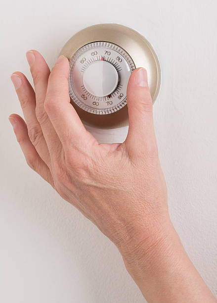 Home Thermostat Room wall temperature thermostat turn  dial to set Furnace stock pictures, royalty-free photos & images