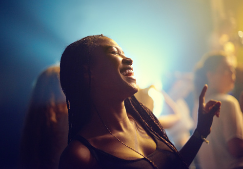 A young girl partying in a club and moving to the music. This concert was created for the sole purpose of this photo shoot, featuring 300 models and 3 live bands. All people in this shoot are model released.