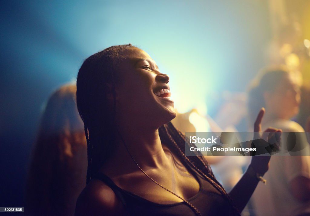 Letting the music take over her A young girl partying in a club and moving to the music. This concert was created for the sole purpose of this photo shoot, featuring 300 models and 3 live bands. All people in this shoot are model released. Dancing Stock Photo