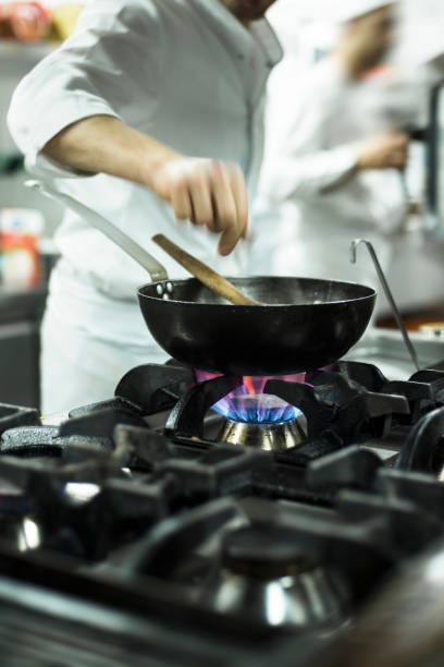 istock Chef sprinkling spices in wok 502134911