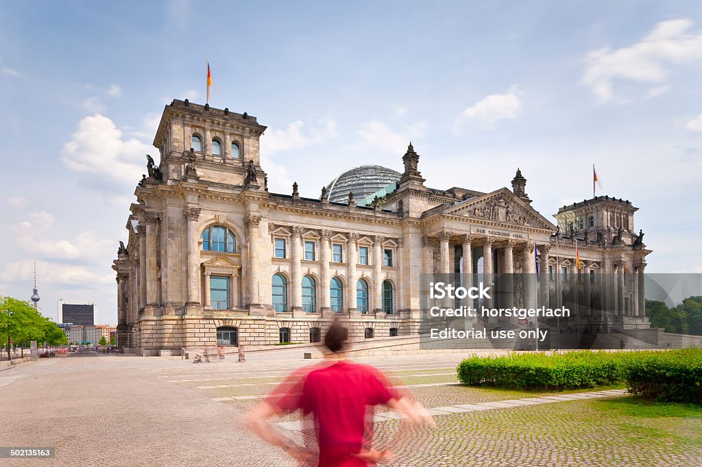 Berlin, Reichstag Building Berlin, Germany - June 06, 2010: View to the Reichstag building with visitors in front on a hot summer afternoon. The Gate is the most well-known landmark of Germany. Construction bagan in 1871. Long exposure with tilt and shift lenses. Ancient Stock Photo