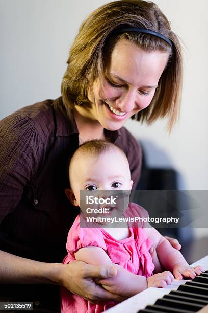 Excited Mother And Baby Playing Piano Vertical Stock Photo - Download Image Now - 2-5 Months, Artist, Arts Culture and Entertainment