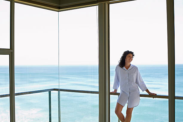 istock Woman Looking Away While Leaning On Railing In Balcony 502135779