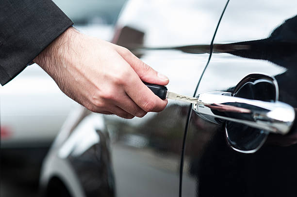 istock Man inserting car key into the door lock 502136077