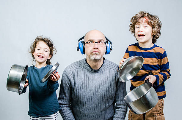 Father discouraged by kids making noise with cauldrons Father discouraged by kids making noise with cauldrons and lid, studio shot on white background rolling eyes irritation displeased facial expression stock pictures, royalty-free photos & images