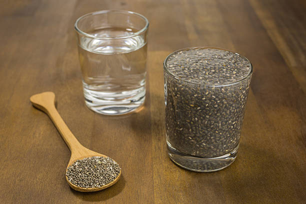 tiny chia seeds soaking in water Chia seeds soaking in water. Chia seeds are loaded with nutrients while also being low on calories. chia seed stock pictures, royalty-free photos & images