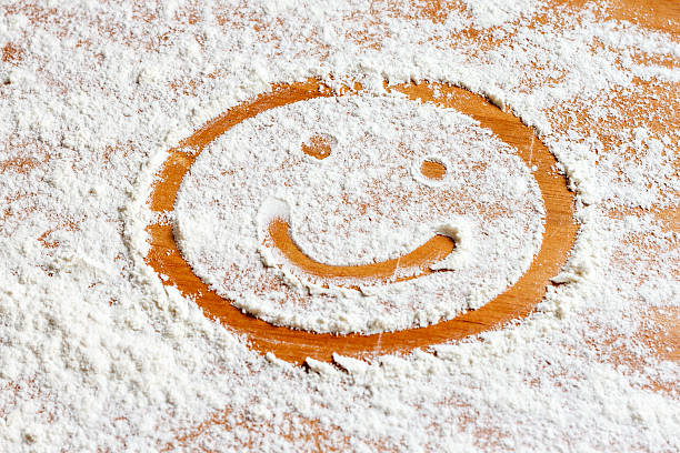 Smiling face on flour stock photo