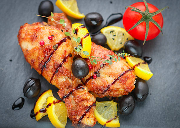 istock Roast chicken with lemon, olives, tomato and thyme with balsamic 502152128