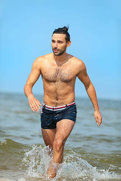 istock Handsome Man Going Out Of Sea 502155267