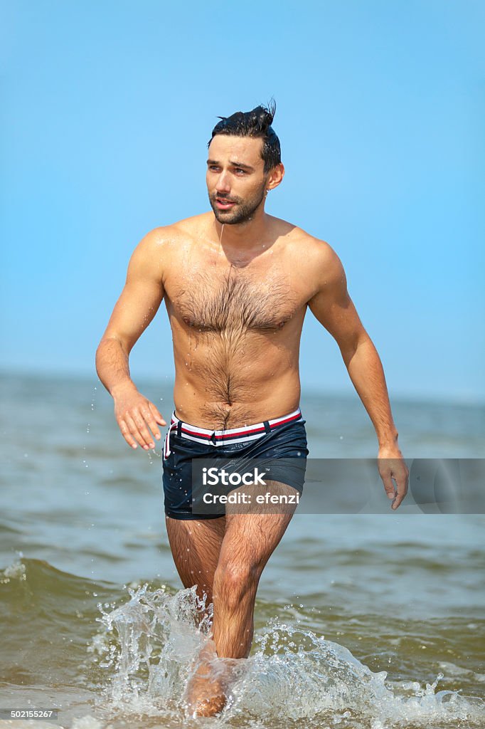 Handsome Man Going Out Of Sea Young handsome man going out of the Baltic sea. Swinoujscie, Poland. 20-29 Years Stock Photo