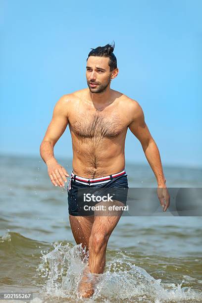 Handsome Man Going Out Of Sea Stock Photo - Download Image Now - 20-29 Years, Active Lifestyle, Activity