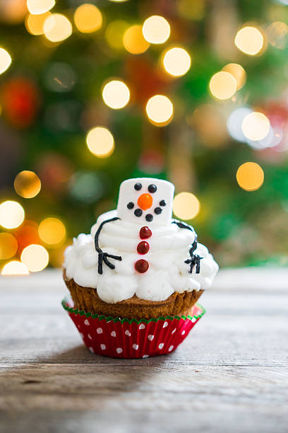 istock Snowman cupcake on wooden background 502155438