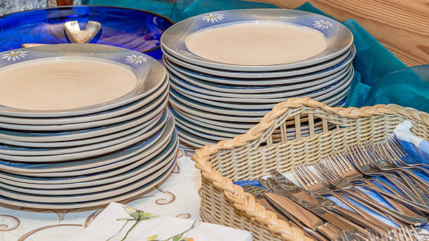 Plates and cutlery in home-buffet in graduation party stock photo