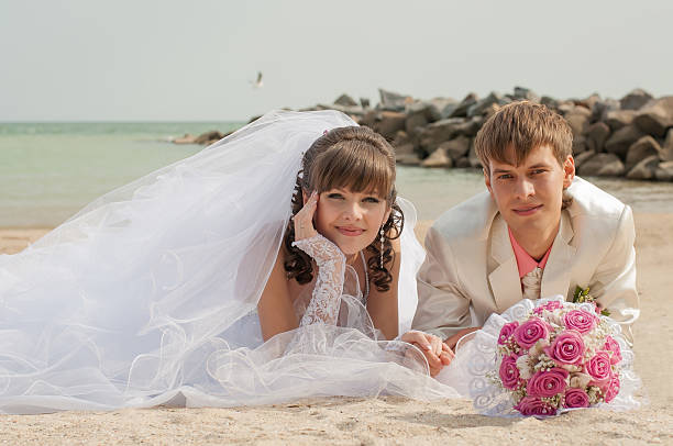 istock Young and beautiful bride and groom on the beach 502156651