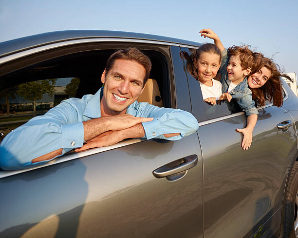 istock Happy family leaning out car windows 502156762