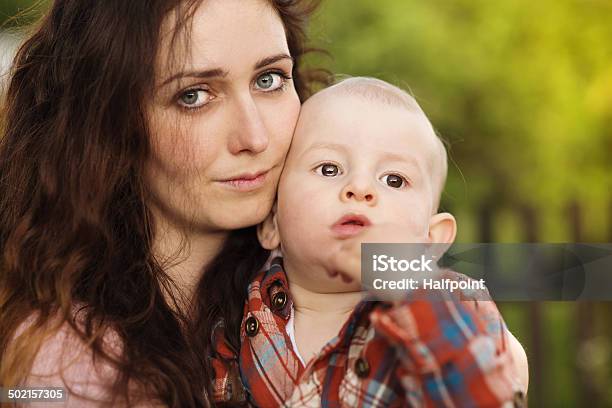 Mother Holding Her Son Stock Photo - Download Image Now - Sadness, Mother, Child
