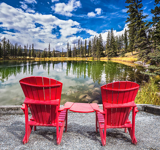 istock Two red plastic chairs on the lake 502158464