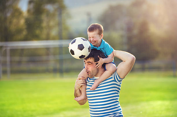istock Father and son playing football 502158571