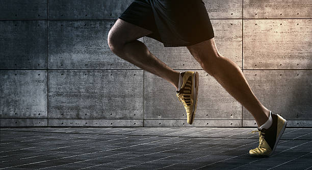 Urban running Close up of urban runner's legs run on the street with copy space endurance photos stock pictures, royalty-free photos & images