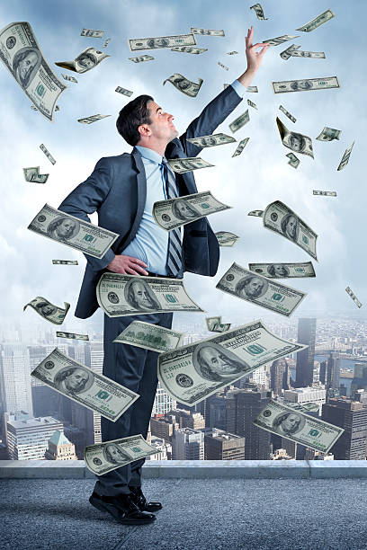 istock Businessman Reaching For Money Falling From Sky 502160354