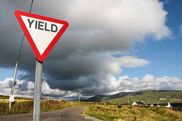 Give way sign with dark clouds in Ireland