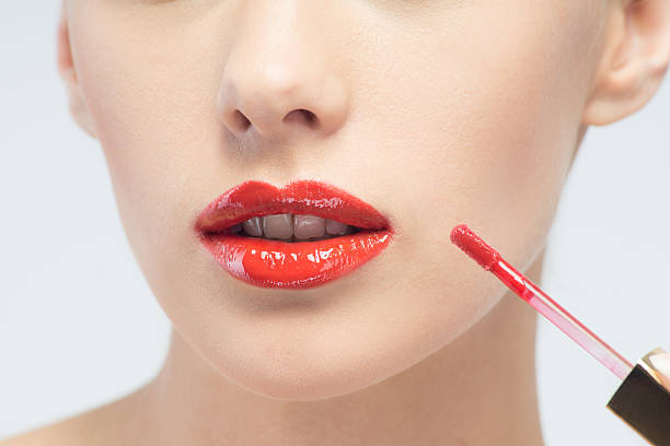 istock Beautiful woman applying lip gloss 502160917