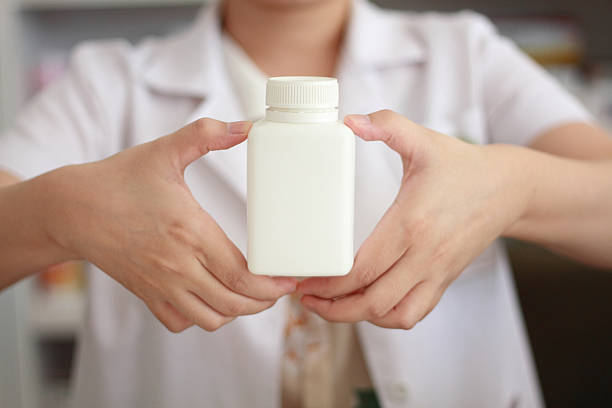 istock pharmacist hand holding medicine bottle 502161280
