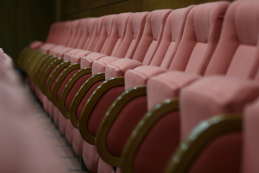 Row of pink seats in a Conference Room