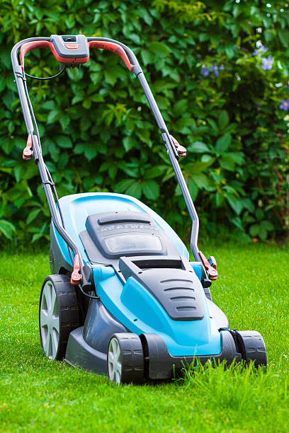 istock blue lawn mower on green grass 502162565