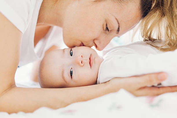 istock Mother kissing baby on cheek 502177238