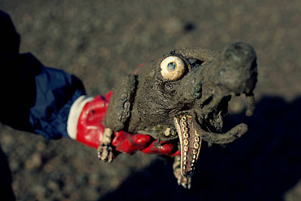 volunteer holding a dirty dog toy found in the river Thames