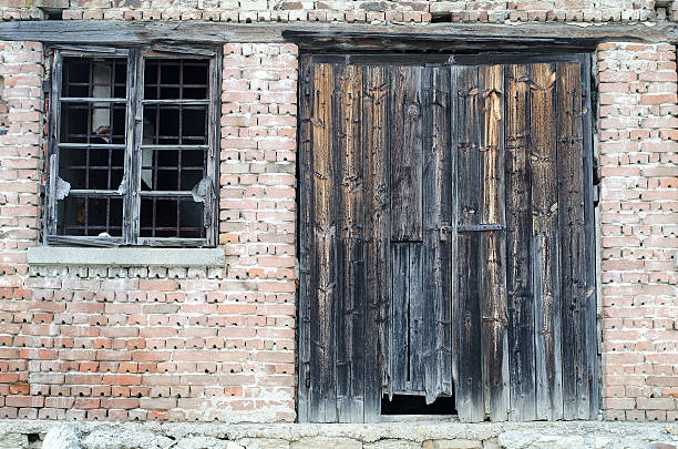 istock Old wooden gate at brick building 502179552