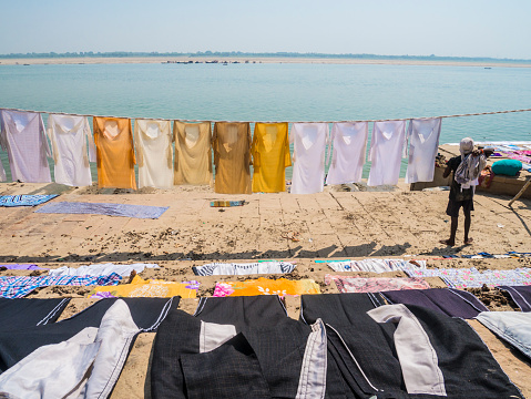 Varanasi, India - October 04, 2015 Drying clothes hanging at the riverbank of the Ganges river in Varanasi India. Laundry is still manually washed in the Ganges waters and dried at the ghats of the riverside.