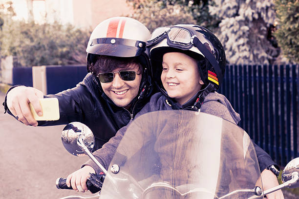 istock motorbikers father and son take a selfie on the road 502182542