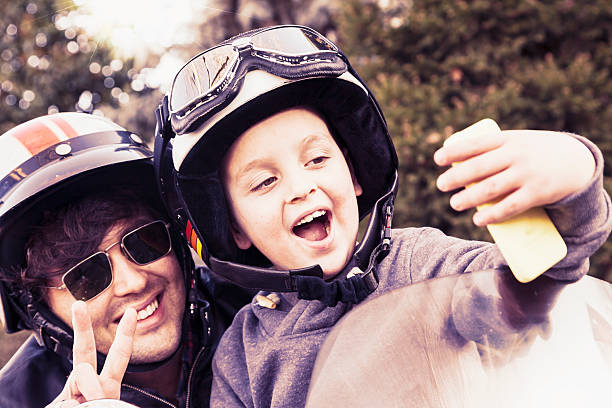 istock father and son motorcyclists take a selfie on the road 502183588