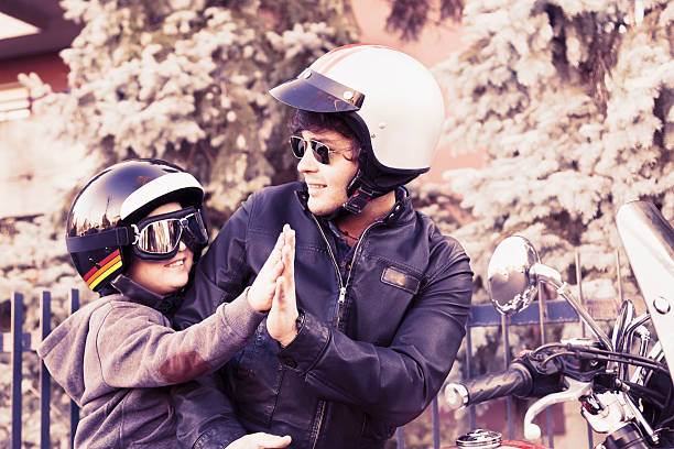 istock father and son motorcyclists high five 502184308