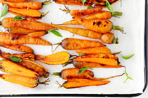 roasted carrots on white platter, food top view