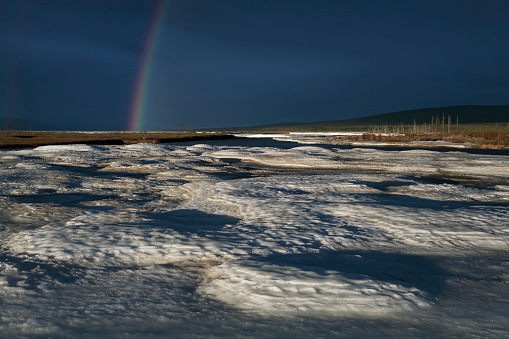 A fragment of a rainbow in the background of ice. Moma River. Yakutia. Russia.