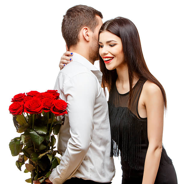 istock Young beautiful couple with flowers isolated on white 502188230