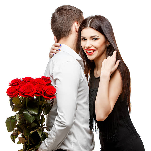 istock Young beautiful couple with flowers isolated on white 502188240