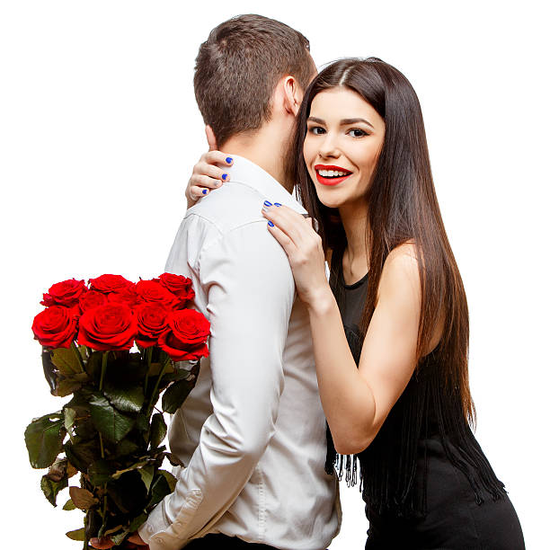 istock Young beautiful couple with flowers isolated on white 502188258