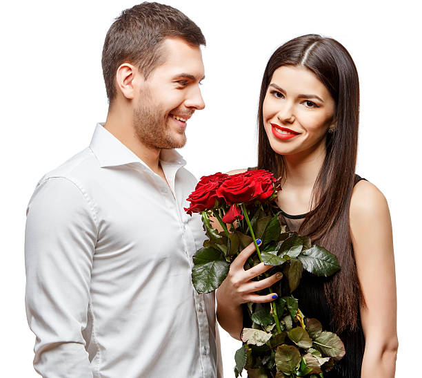 istock Young beautiful couple with flowers isolated on white 502188272