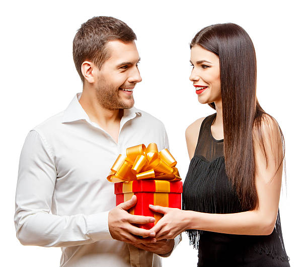 istock Young beautiful couple with present isolated on white 502188434