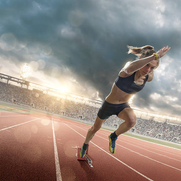 istock Woman Athlete Sprinting From Blocks on Running Track in Stadium 502189238