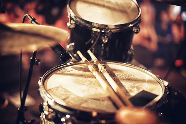 Beats waiting to happen Drum kit set up on a stage with a crowd in the backgroundhttp://195.154.178.81/DATA/i_collage/pi/shoots/782610.jpg drum kit photos stock pictures, royalty-free photos & images