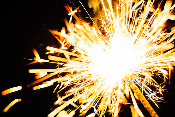 istock Bright Christmas sparkler closeup on a black background, soft focus 502193622